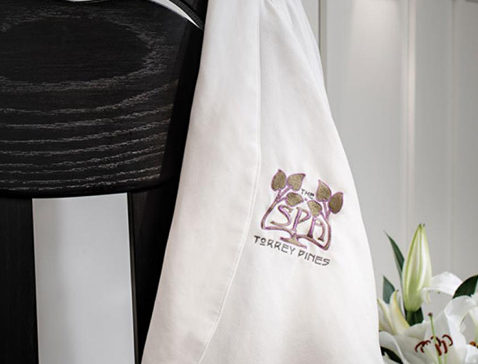 Lodge Torrey Pines Spa  branded robe over a chair