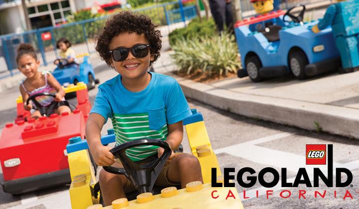 Young child driving Lego car