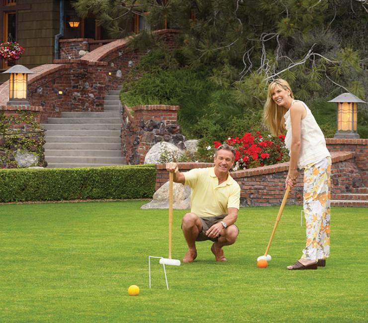 Couple enjoying a round of croquet on the Arroyo Terrace