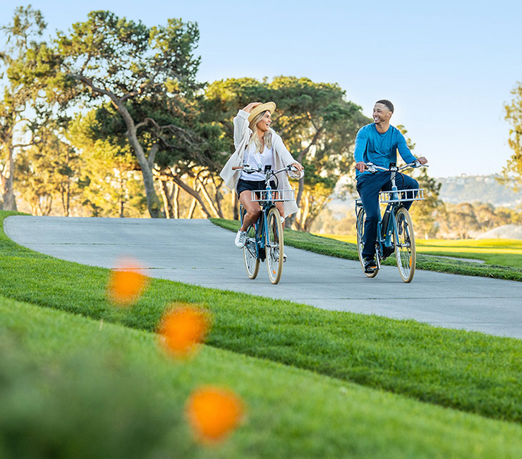 COuple riding electric bikes at the Lodge at Torrey Pines