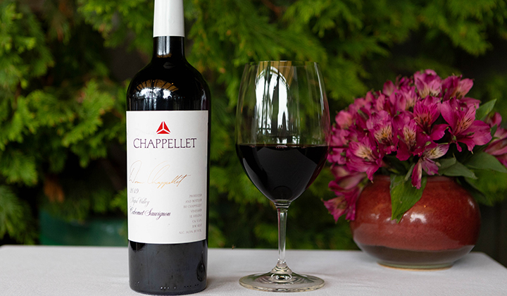 A bottle and glass of wine from Chappellet Winery being featured at the Artisan Table Signature Wine Dinner at A.R. Valentien at The Lodge at Torrey Pines in La Jolla, CA.