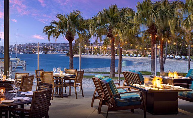 Exterior patio at Dockside 1953 with firepits overlooking Mission Bay at Dusk