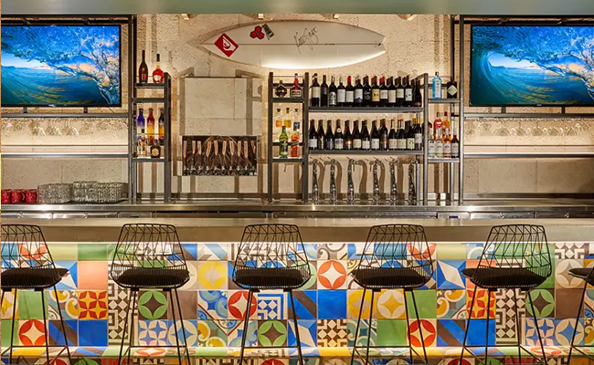 Cozy & Coastal Charm: Bar area with colorful patterned tile at Duke's in La Jolla