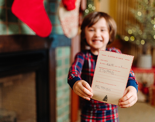 Young boy holding up letter to Santa at The Lodge at Torrey Pines
