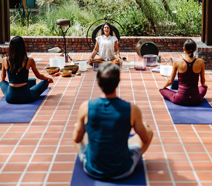 Guests practicing yoga outdoors at The Lodge at Torrey Pines in La Jolla, CA