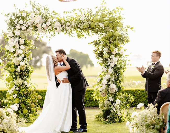 Couple kiss before after the wedding celebration at The Lodge at Torrey Pines.