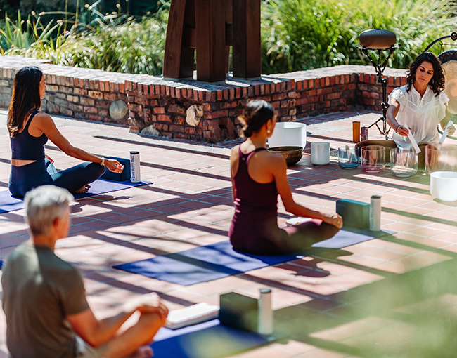 Meeting group enjoying yoga in the courtyard at The Lodge at Torrey Pines
