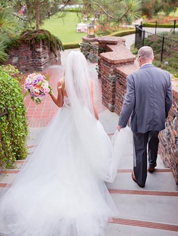 Father walking with bride on brick staircase at The Lodge at Torrey Pines