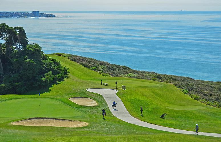 Aerial view of golfers walking along the path to their next tee at the Torrey Pines Golf Course