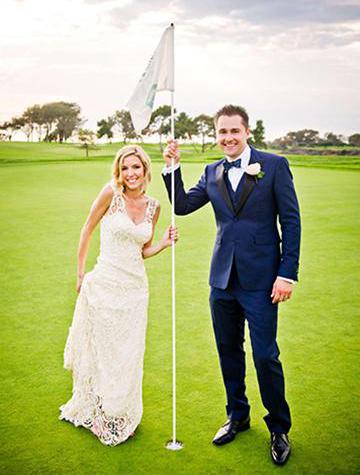 Wedding couple standing on the 18th hole on at the Lodge at Torrey Pines Golf Course