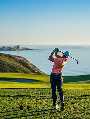 Golfer finishing his swing at the Torrey Pines Golf Course in La Jolla, California