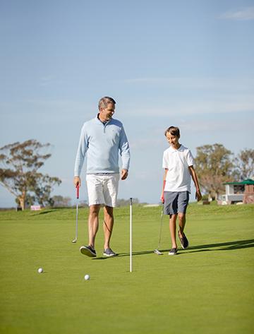Father and son on the putting green