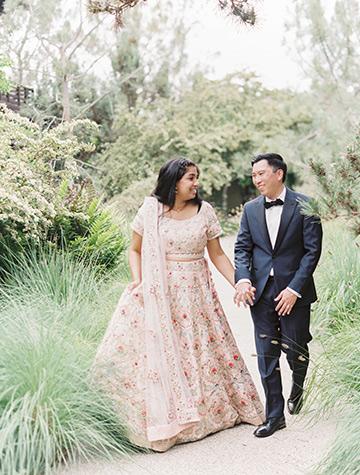 The bride and groom taking a stroll through the botanical reserve at The Lodge at Torrey Pines on their boho wedding day.
